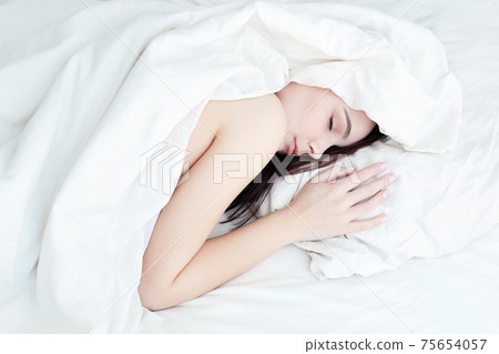 Lifestyle portrait of cute girl sleeping on bed Lifestyle portrait of cute girl sleeping on bed 75654057
