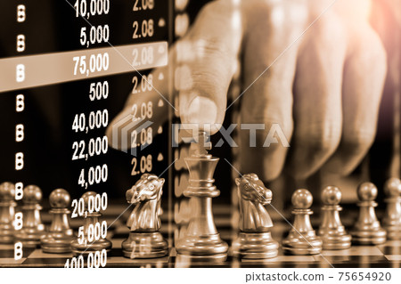 Chess game on chess board behind business man background. Business concept to present financial information and marketing strategy analysis. Investment target in global economy and digital commercial. 75654920