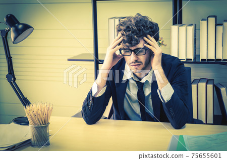 Depressed office worker business manger with frustrated expression on office desk feeling despair about business problem. Depressed office worker business manger with frustrated expression on office desk feeling despair about business problem. 75655601