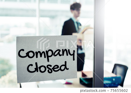 Company closed on windows of an empty office with business man packing beloning walking out of business by economic recession concept. Company closed on windows of an empty office with business man packing beloning walking out of business by economic recession concept. 75655602