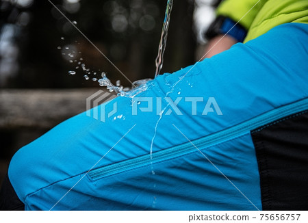 Hydrophobic effect on blue waterproof fabric on mountain trousers. 75656757