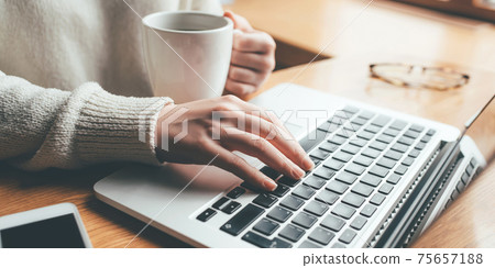 Young woman working in home on her laptop computer. Young woman working in home on her laptop computer. 75657188