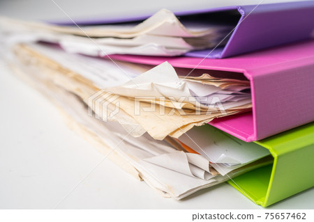 File Folder Binder stack of multi color on table in office. File Folder Binder stack of multi color on table in office. 75657462