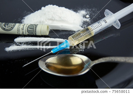 Drugs. Cocaine, money, syringe and spoon. 75658011