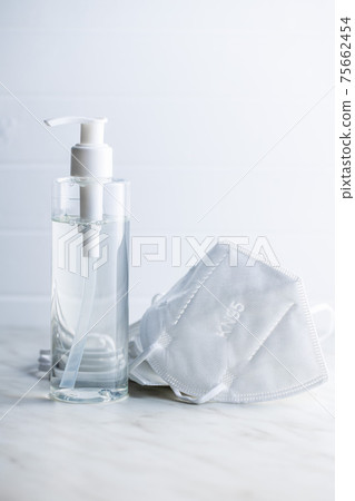 Coronavirus prevention hand sanitizer and kn95 respirator mask. Hand disinfectant gel in pump bottle. Coronavirus prevention hand sanitizer and kn95 respirator mask. Hand disinfectant gel in pump bottle. 75662454