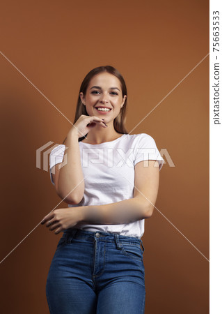 young pretty girl with blond hair posing cheerful on brown background, lifestyle people concept young pretty girl with blond hair posing cheerful on brown background, lifestyle people concept 75663533