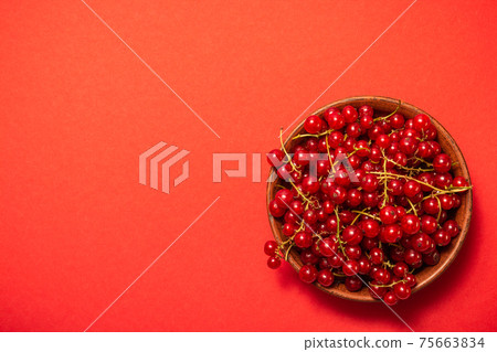 Red currant in clay bowl on red background. Fruit bowl. Delicious food. Copy space. High quality close up photo Red currant in clay bowl on red background. Fruit bowl. Delicious food. Copy space. High quality close up photo 75663834