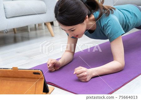 Woman exercise at home 75664013