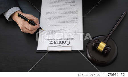 Professional lawyer considering with contract papers in courtroom. Justice, Law, Attorney and Court judge concept. 75664452