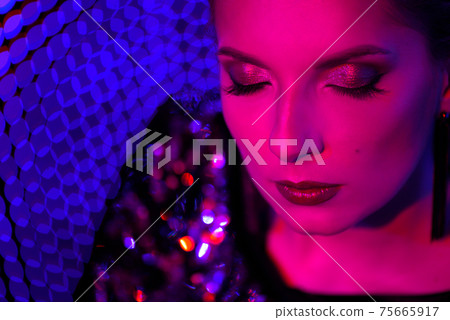Studio shot of neon close up portrait of young woman Studio shot of neon close up portrait of young woman 75665917