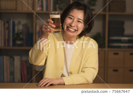 A woman toasting to the camera A woman toasting to the camera 75667647