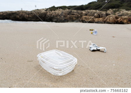 used plastic container thrown on the beach used plastic container thrown on the beach 75668182