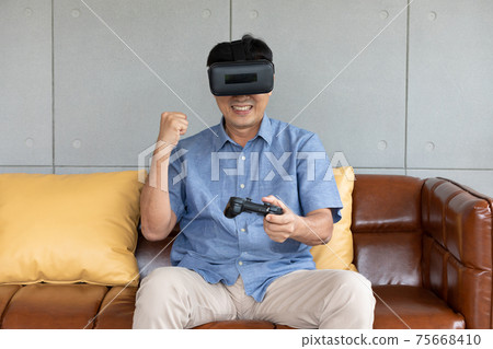 asian senior man enjoying, playing game and wearing VR headsets asian senior man enjoying, playing game and wearing VR headsets 75668410