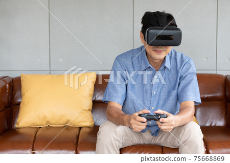 asian senior man enjoying, playing game and wearing VR headsets asian senior man enjoying, playing game and wearing VR headsets 75668869