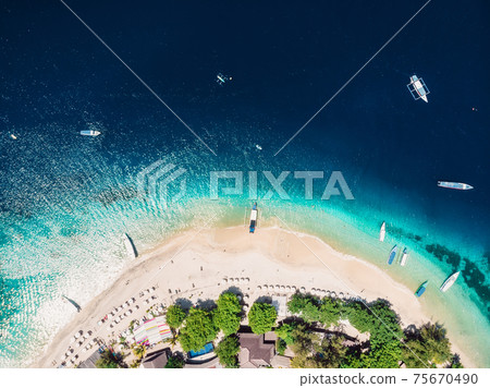 Island with tropical beach and crystal ocean, aerial view. Gili islands Island with tropical beach and crystal ocean, aerial view. Gili islands 75670490