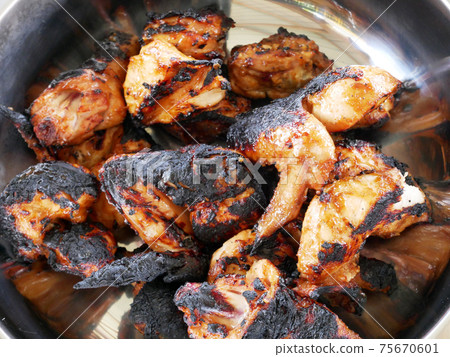 Pieces of chicken that have been grilled and ready to serve. Has been seasoned and marinated with special spices before being grilled. 75670601