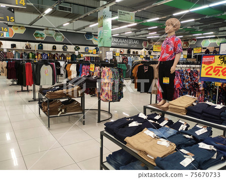 SEREMBAN, MALAYSIA -MARCH 2021: Various types of clothes are being sold in supermarkets. Displayed by hanging or placed in a container. Price tags are displayed for customer reference SEREMBAN, MALAYSIA -MARCH 2021: Various types of clothes are being sold in supermarkets. Displayed by hanging or placed in a container. Price tags are displayed for customer reference 75670733