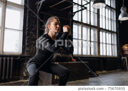 Young girl doing sports in the gym. Atmospheric gym Young girl doing sports in the gym. Atmospheric gym 75670930