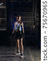 Young girl stands in an atmospheric gym. Sport 75670965