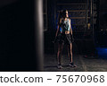 Young girl stands in an atmospheric gym. Sport 75670968