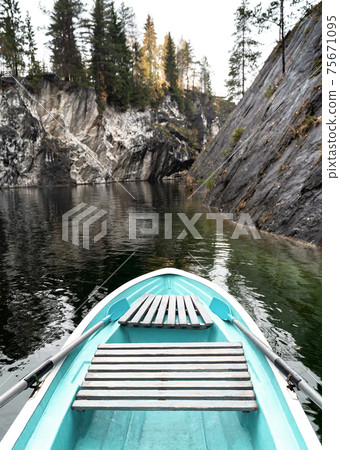 White and turquoise boat in mountain lake natural background. Tourism and hiking concept. 75671095