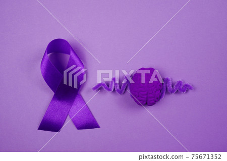 Purple day. World epilepsy day. Purple ribbon and brain on purple background Purple day. World epilepsy day. Purple ribbon and brain on purple background 75671352