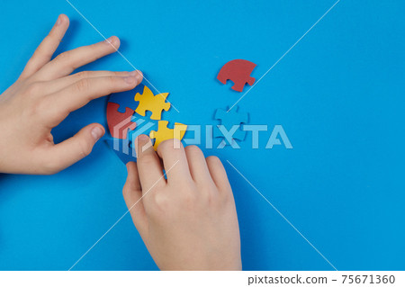 World Autism Awareness day, mental health care concept with puzzle or jigsaw pattern on heart with child's hands 75671360