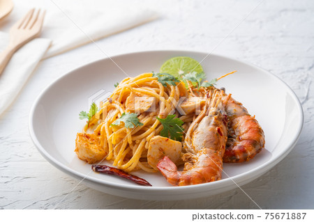 Spaghetti Tom Yum Kung,Thai style fusion food, spicy pasta with Giant freshwater prawns in tom yum sauce. Spaghetti Tom Yum Kung,Thai style fusion food, spicy pasta with Giant freshwater prawns in tom yum sauce. 75671887