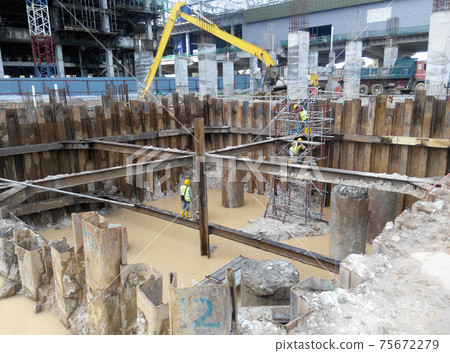 PUTRAJAYA, MALAYSIA -OCTOBER 13, 2017: Sheet pile cofferdam retaining wall at the construction site. It is installed to allow soil excavation and foundation work start. PUTRAJAYA, MALAYSIA -OCTOBER 13, 2017: Sheet pile cofferdam retaining wall at the construction site. It is installed to allow soil excavation and foundation work start. 75672279