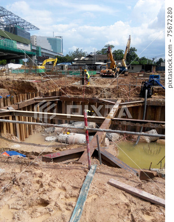 PUTRAJAYA, MALAYSIA -OCTOBER 13, 2017: Sheet pile cofferdam retaining wall at the construction site. It is installed to allow soil excavation and foundation work start.  75672280