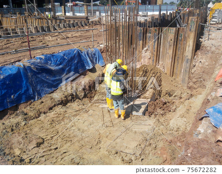 PUTRAJAYA, MALAYSIA -OCTOBER 13, 2017: Sheet pile cofferdam retaining wall at the construction site. It is installed to allow soil excavation and foundation work start. PUTRAJAYA, MALAYSIA -OCTOBER 13, 2017: Sheet pile cofferdam retaining wall at the construction site. It is installed to allow soil excavation and foundation work start. 75672282