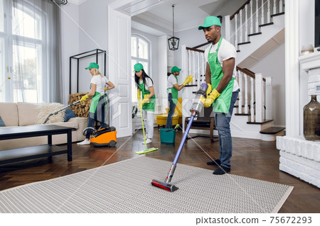 Group of four multiracial people cleaning client house Group of four multiracial people cleaning client house 75672293