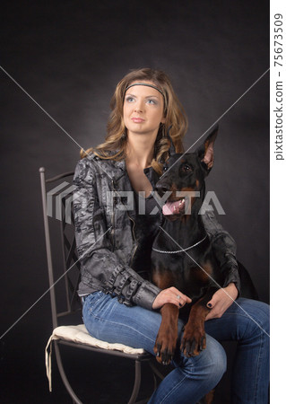 Woman with dobermann dog 75673509