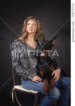 Woman with dobermann dog 75673510