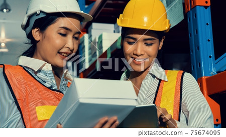 Female warehouse worker working at the storehouse Female warehouse worker working at the storehouse 75674095