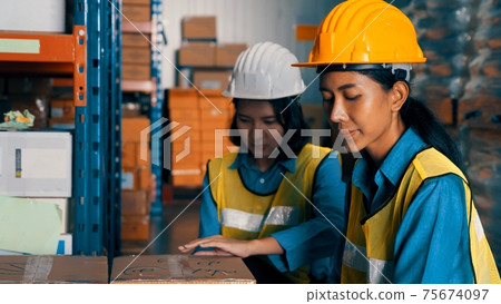 Female warehouse worker working at the storehouse 75674097