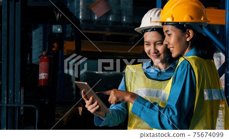 Female warehouse worker working at the storehouse 75674099