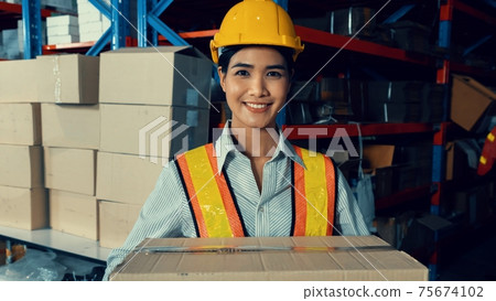Portrait of young Asian woman warehouse worker smiling in the storehouse Portrait of young Asian woman warehouse worker smiling in the storehouse 75674102