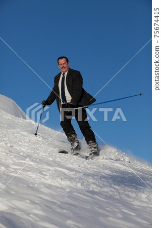 Man in business sute on ski Man in business sute on ski 75674415