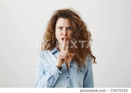 Close up portrait of cute lovely attractive uncertain unsure with entrepreneur making hush gesture isolated on gray background copy-space 75675595