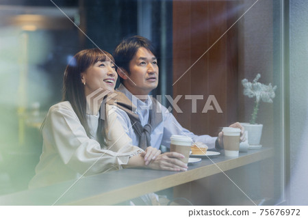 Middle-aged couple spending time in a cafe Middle-aged couple spending time in a cafe 75676972