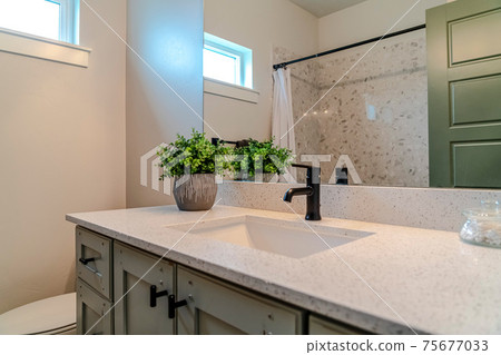 Bathroom interior of home with single basin sink over cabinets and countertop 75677033