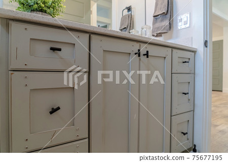 Bathroom interior of home with close up view of the wooden vanity cabinet Bathroom interior of home with close up view of the wooden vanity cabinet 75677195