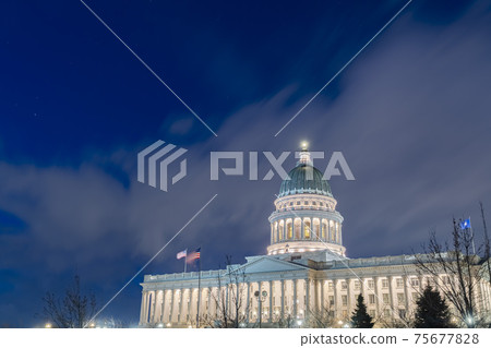 Facade of majestic Utah State Capital Building glowing against sky and clouds 75677828