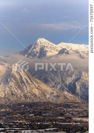 Snow covered Mount Timpanogos with residential landscape in the foreground Snow covered Mount Timpanogos with residential landscape in the foreground 75678897