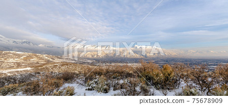Panoramic view of Mount Timpanogos and the valley blanketed with snow in winter Panoramic view of Mount Timpanogos and the valley blanketed with snow in winter 75678909