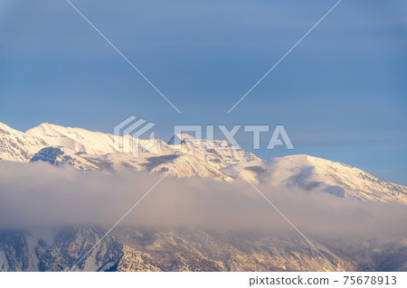 Scenic winter view of majestic Mount Timpanogos with snow against blue sky 75678913