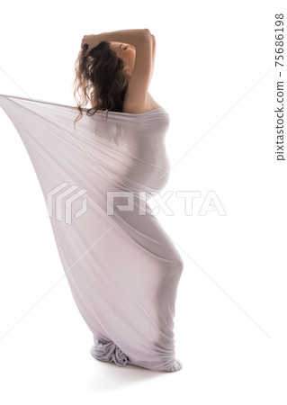 Nude pregnant woman in white cloth in studio Nude pregnant woman in white cloth in studio 75686198