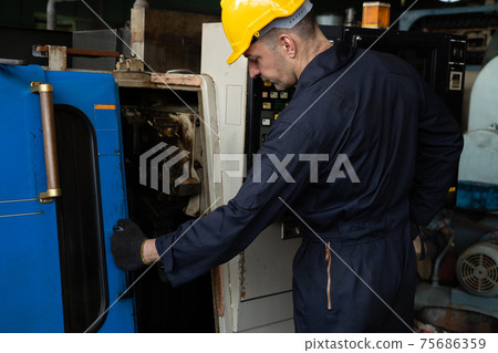 Skillful factory engineer or worker do machine job in manufacturing workshop Skillful factory engineer or worker do machine job in manufacturing workshop 75686359