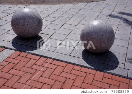 decorative granite balls spheres on sidewalk decorative granite balls spheres on sidewalk 75688859